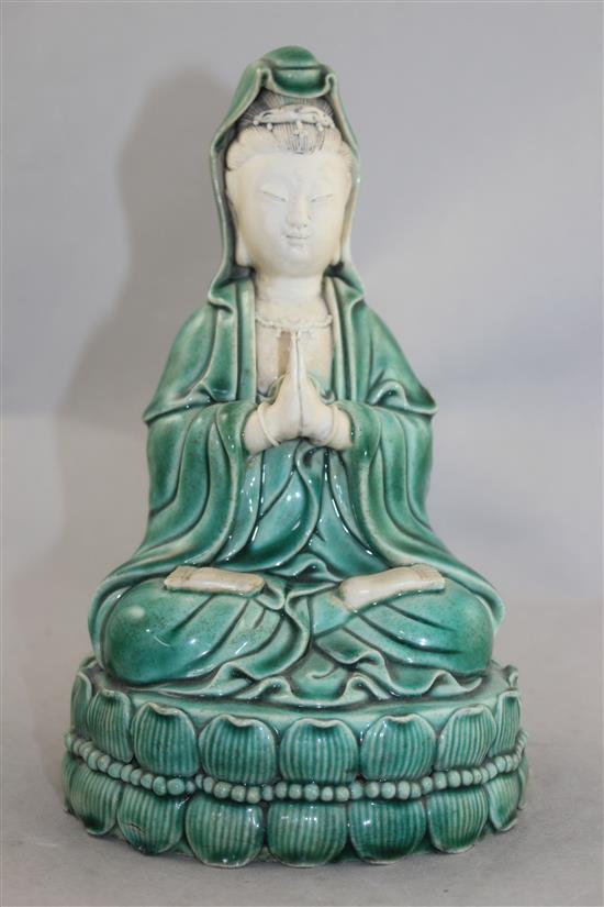A Chinese green glazed biscuit porcelain seated figure of Guanyin, 12cm